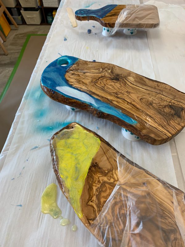 A wooden board with blue and yellow paint on it