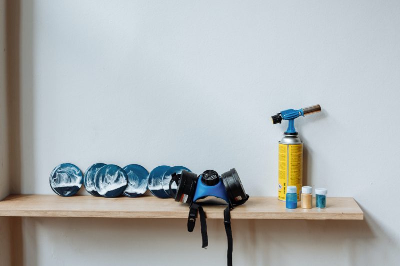 A shelf with blue plates and a fire extinguisher