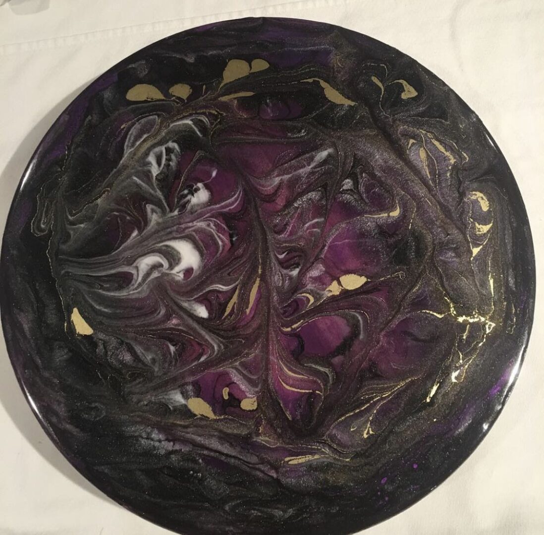 A purple and black plate on top of the table.