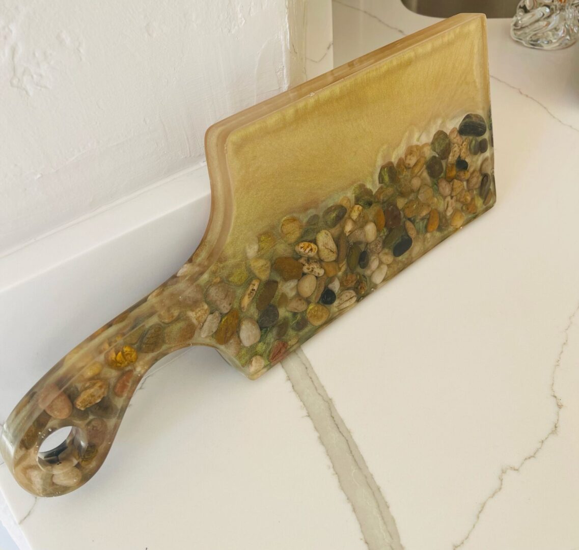 A marble cutting board with rocks on it