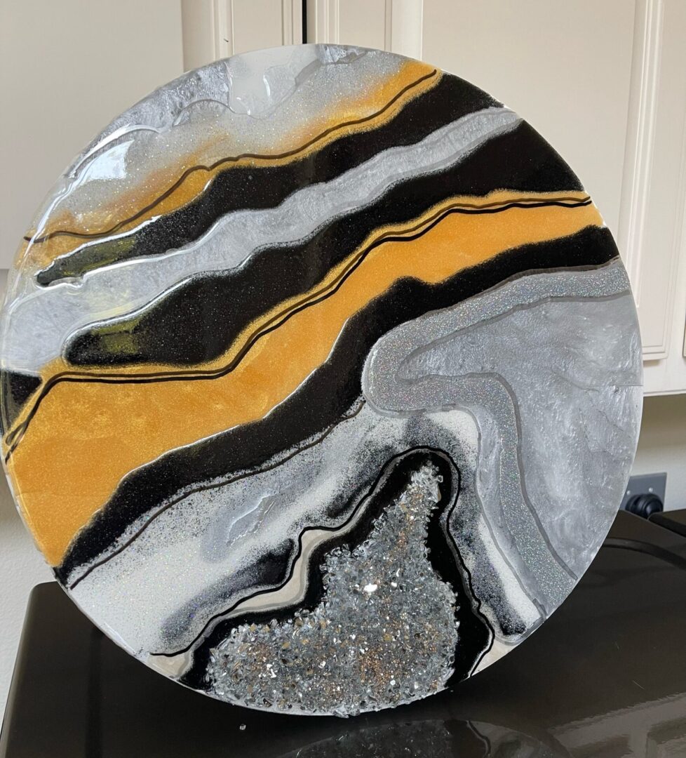 A close up of a plate with black and yellow marble