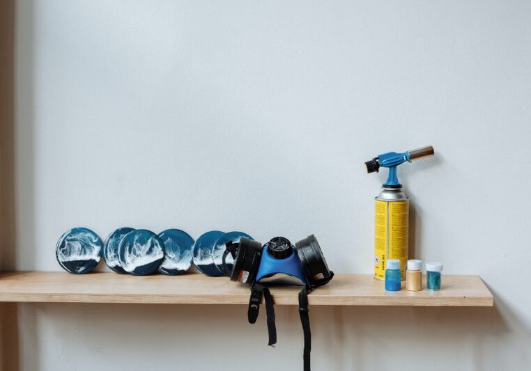 A shelf with blue plates and a fire extinguisher