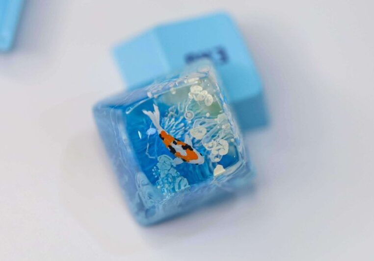 A blue ice cube with a fish on it